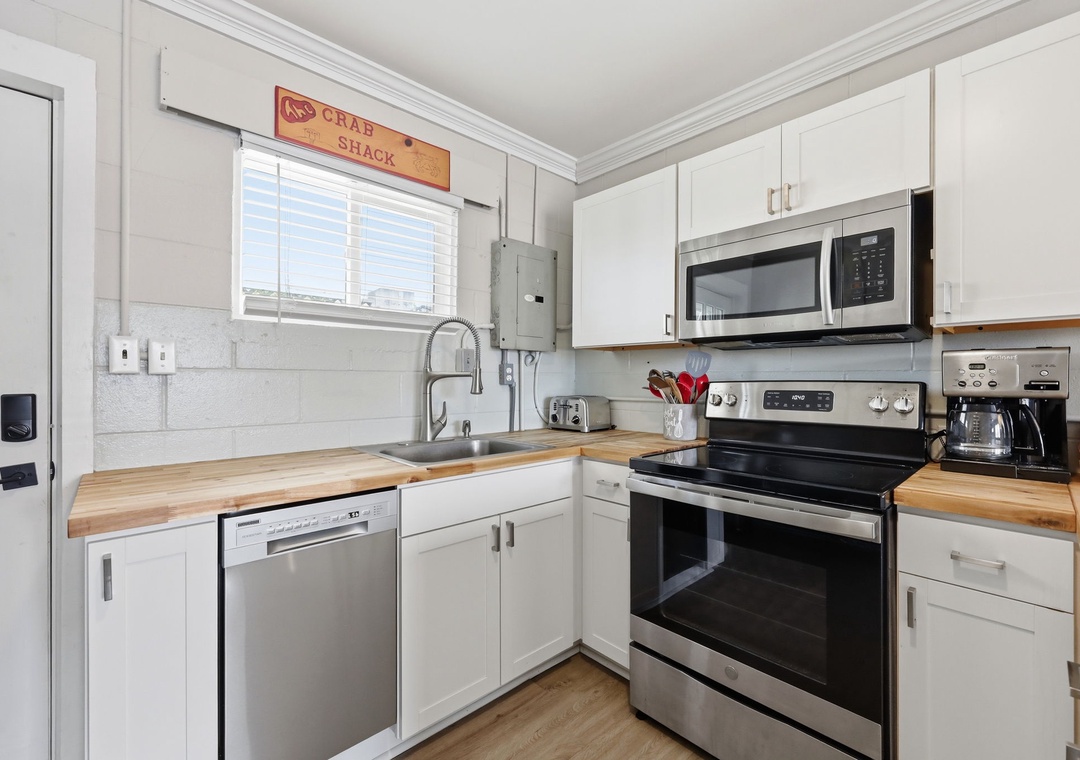 Your fully equipped kitchen features modern appliances and warm wood countertops, making it easy to whip up delicious meals during your stay.