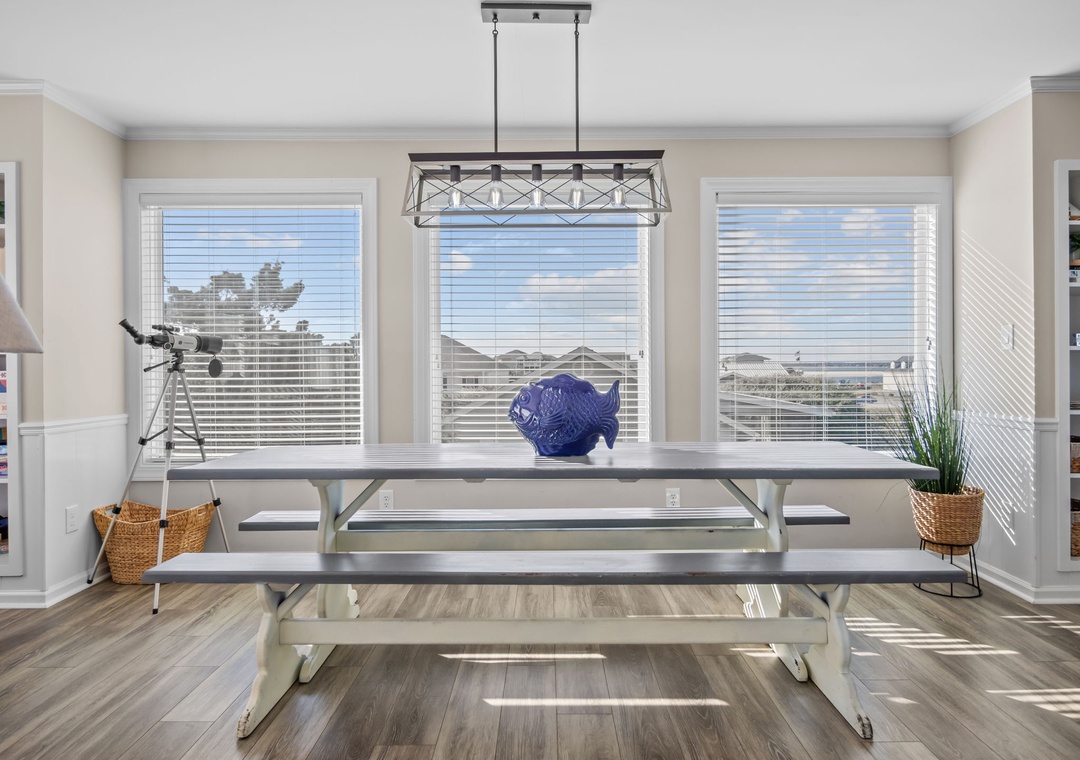 Gather around your spacious dining table with room for everyone, bathed in natural light from expansive windows.