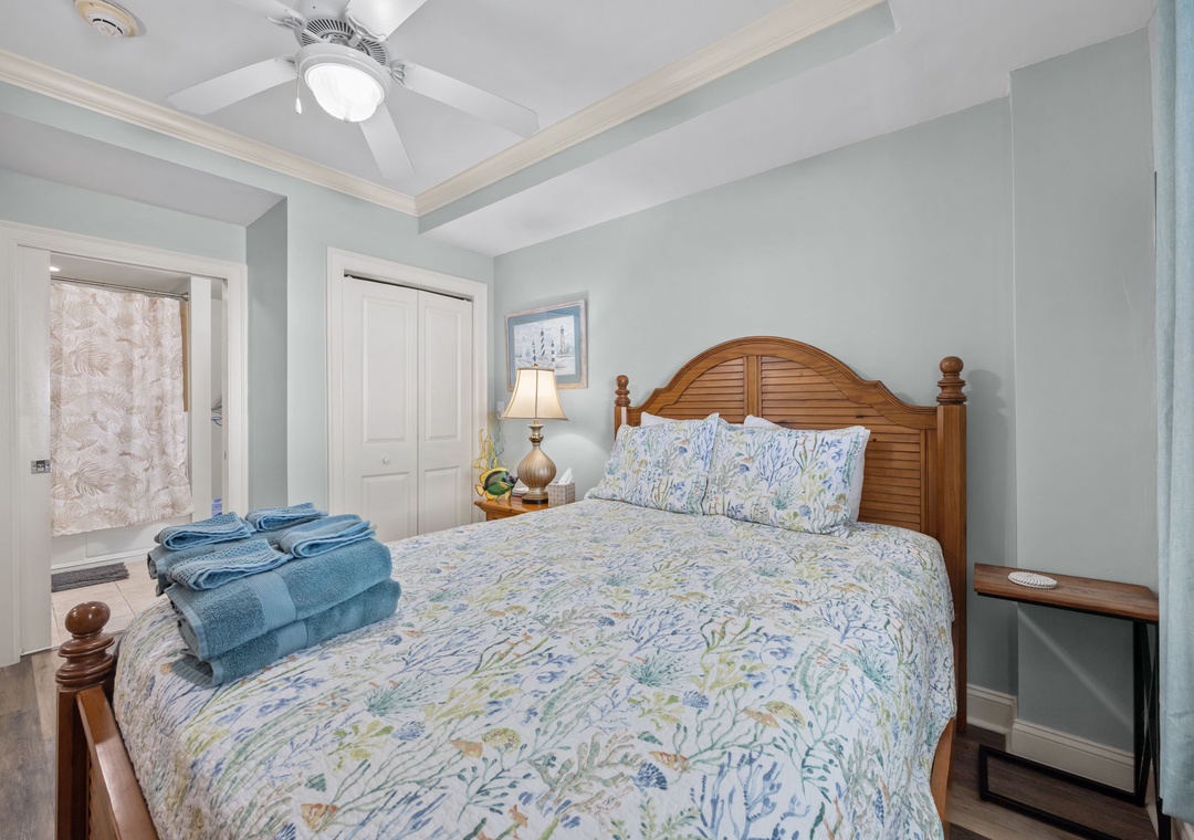 Unwind in your coastal-inspired bedroom with plush blue linens and coastal charm for peaceful nights.