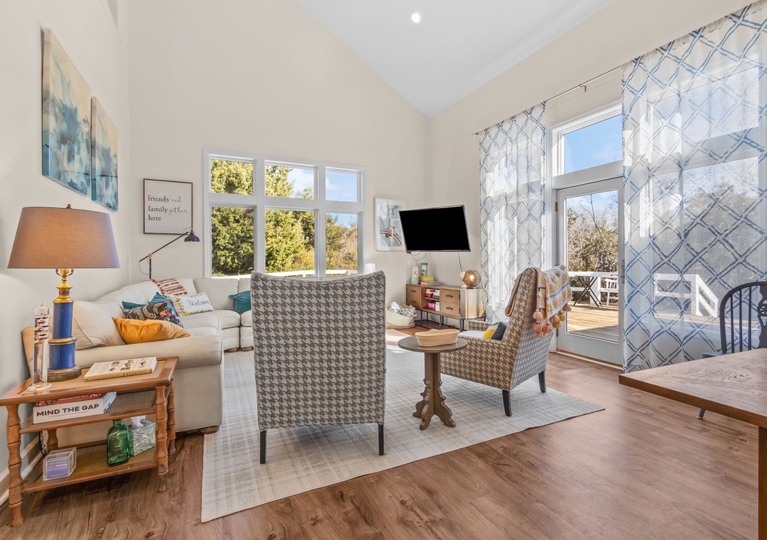 Unwind in your bright, airy living space with plush seating, natural light streaming through large windows, and charming touches throughout.
