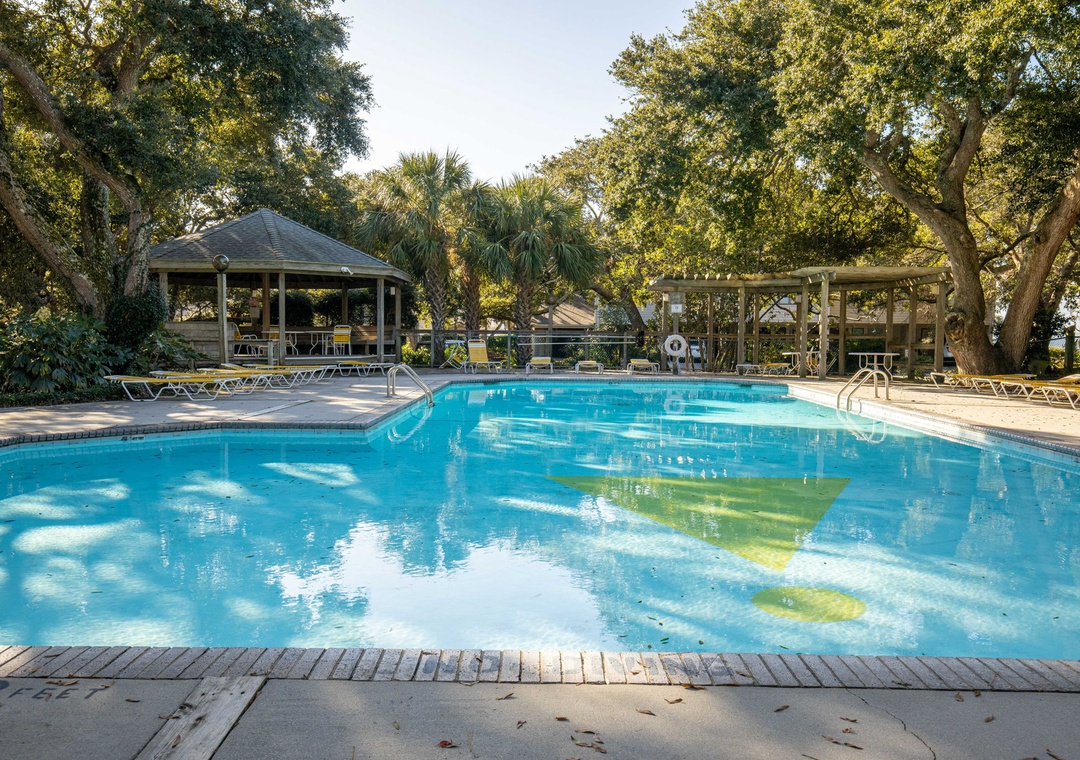 Sparkling pool surrounded by lush trees and gazebos creates your perfect tropical retreat for relaxation and fun.