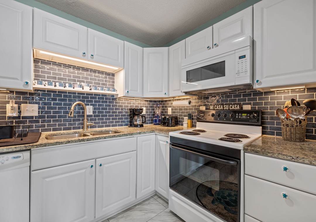 Your fully equipped kitchen awaits with granite countertops, stylish subway tile backsplash, and everything needed to create memorable meals.