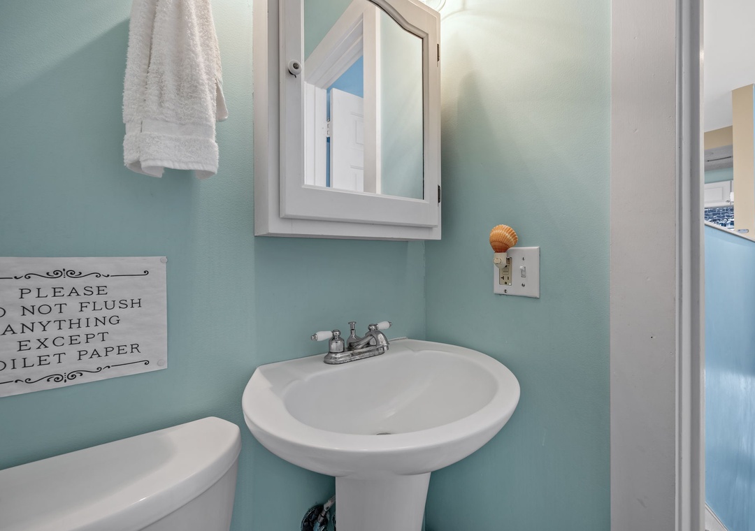 Refresh in your charming coastal-themed bathroom with soft aqua walls, fluffy towels, and thoughtful touches that make you feel at home.