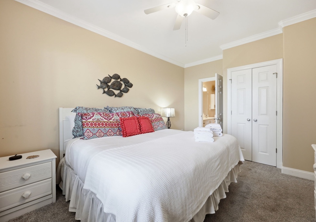 Step into your cozy retreat with a plush bed awaiting, crisp linens ready, and a ceiling fan whispering comfort above. Your private escape features warm tones, ample storage, and an en-suite bathroom just steps away.
