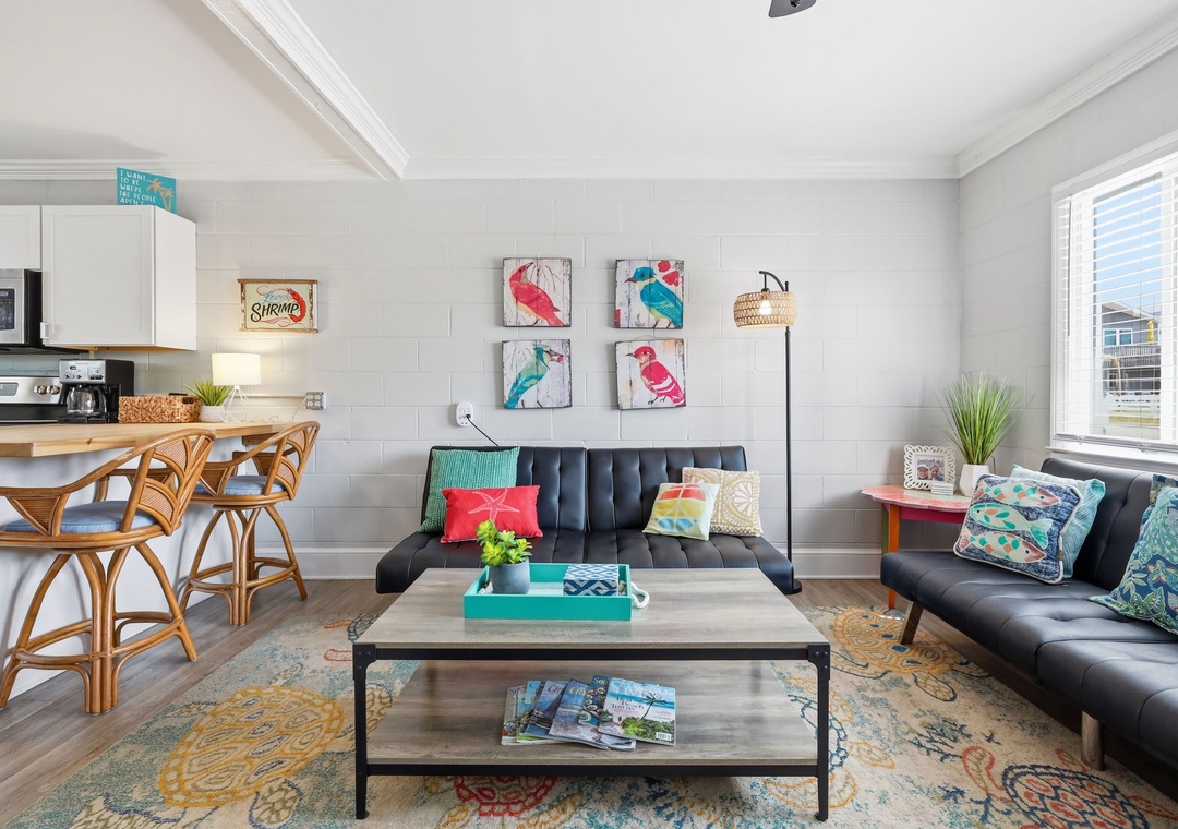 Sink into plush seating and soak in the cheerful beach vibes—your home away from home features a stylish open-concept layout where you can relax, dine, and make memories together.