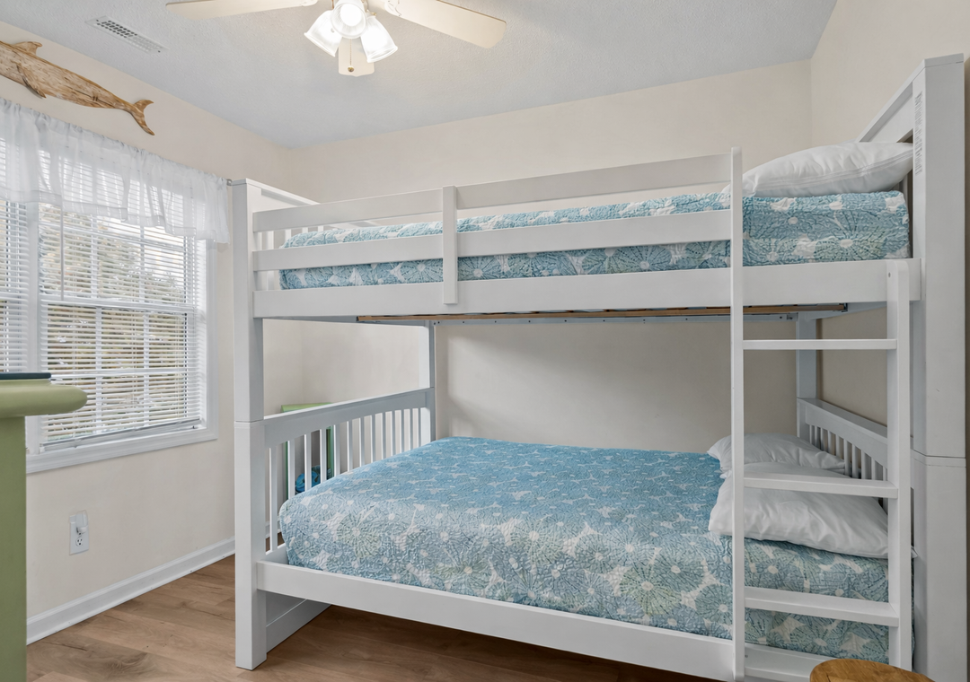 Sleep soundly in your bright bunk room where coastal blue linens and natural light create the perfect retreat for kids or groups.