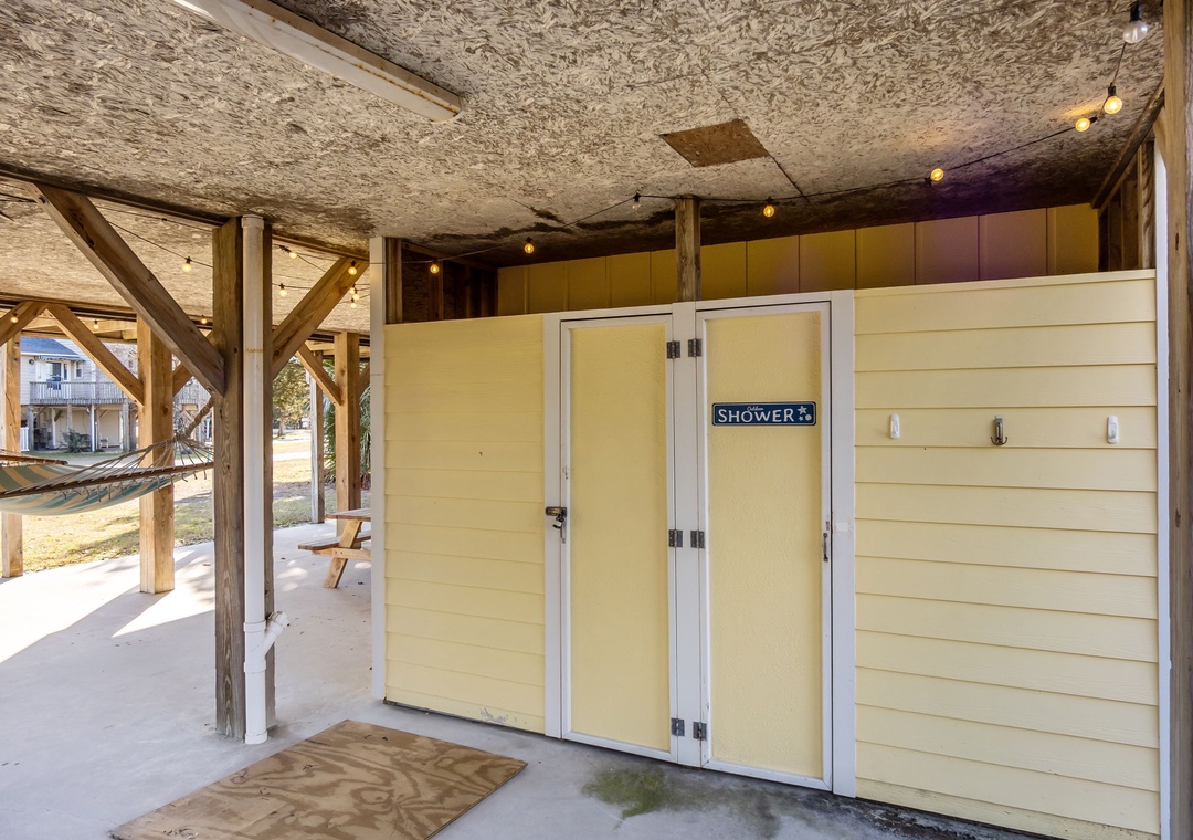 Rinse off salt and sand in your private outdoor shower after beach days, complete with warm lighting and coastal charm.