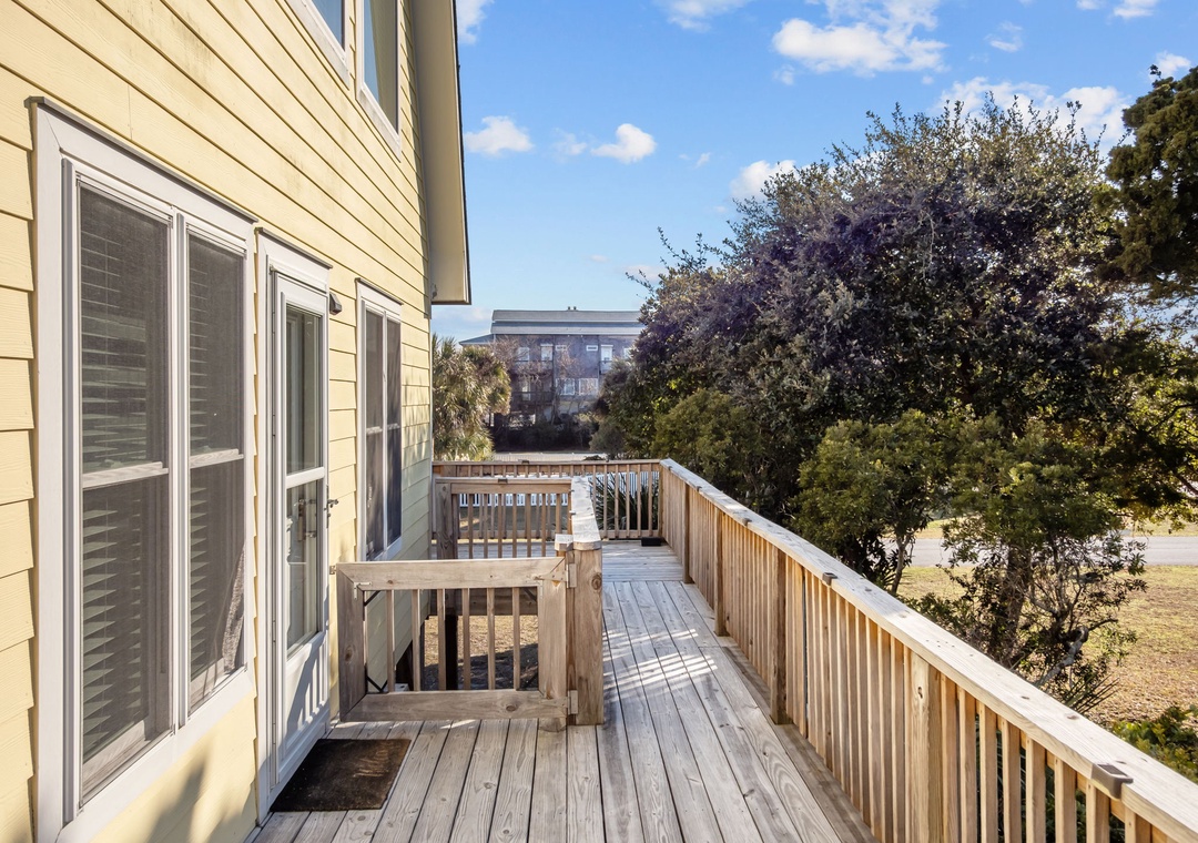 Step onto your private deck and breathe in the fresh air while enjoying peaceful neighborhood views surrounded by mature trees.