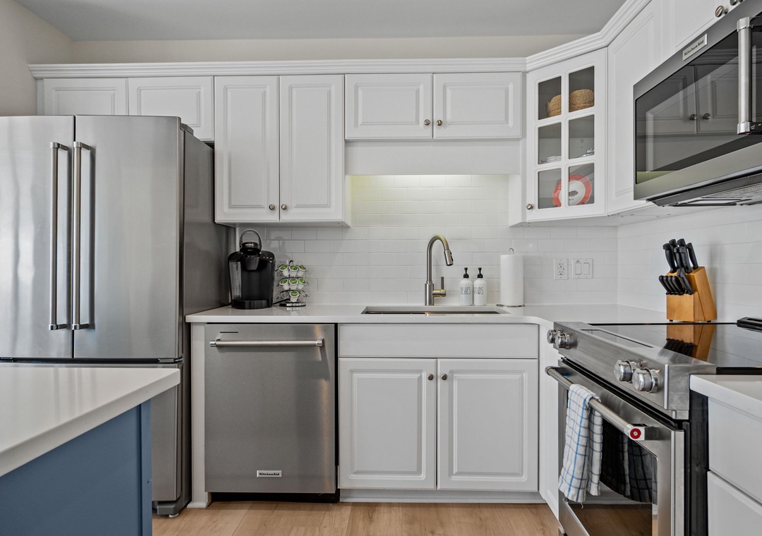 Step into your fully equipped kitchen with stainless steel appliances and crisp white cabinetry, ready for your culinary adventures.