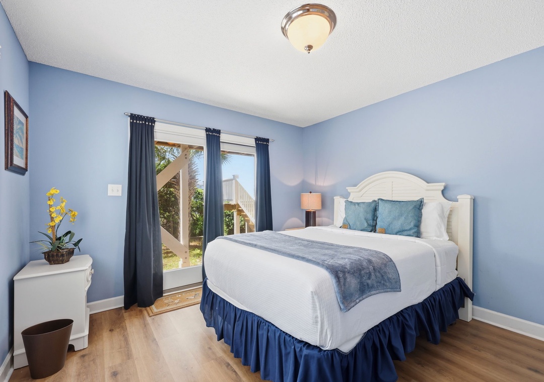 Relax in your serene bedroom, where calming blue tones and crisp linens invite restful nights, while sliding doors open to tropical breezes and sunlit moments.
