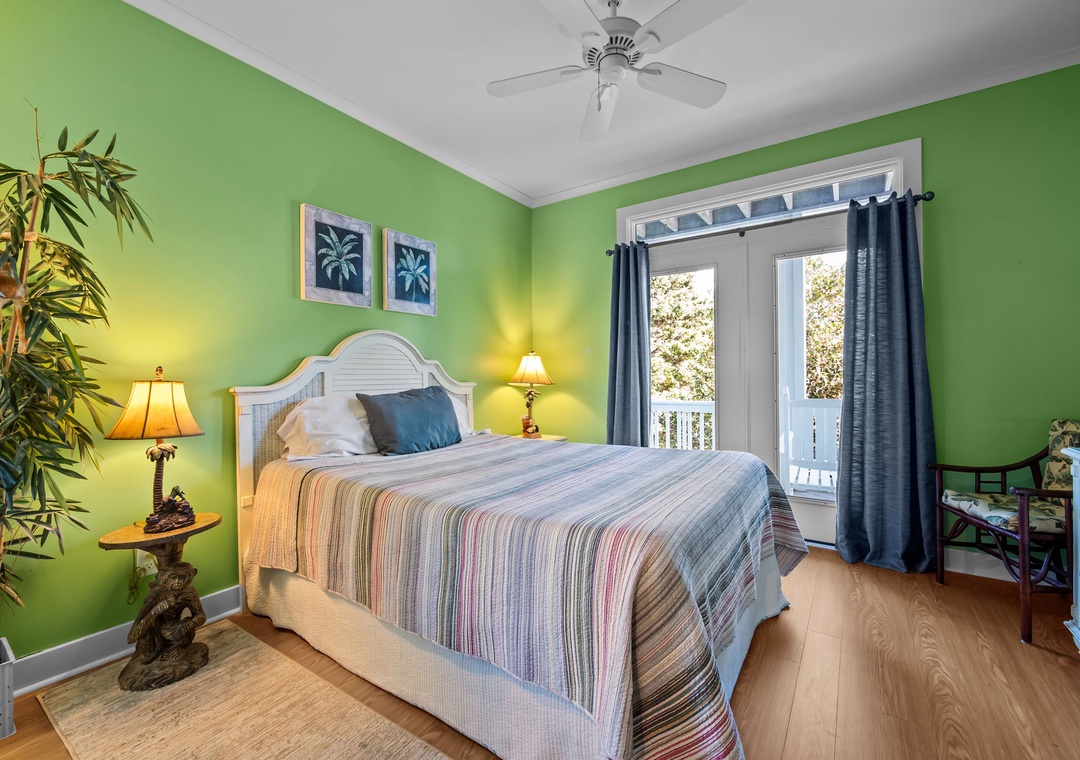 Drift off in this tropical bedroom with vibrant green walls, comfy bed, and private balcony access for morning coffee moments.