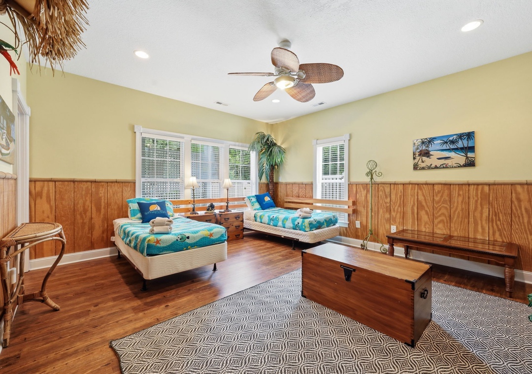 Your coastal retreat awaits with cheerful twin beds, warm wood tones, and tropical touches—perfect for sharing sunny vacation memories with your favorite travel companion.