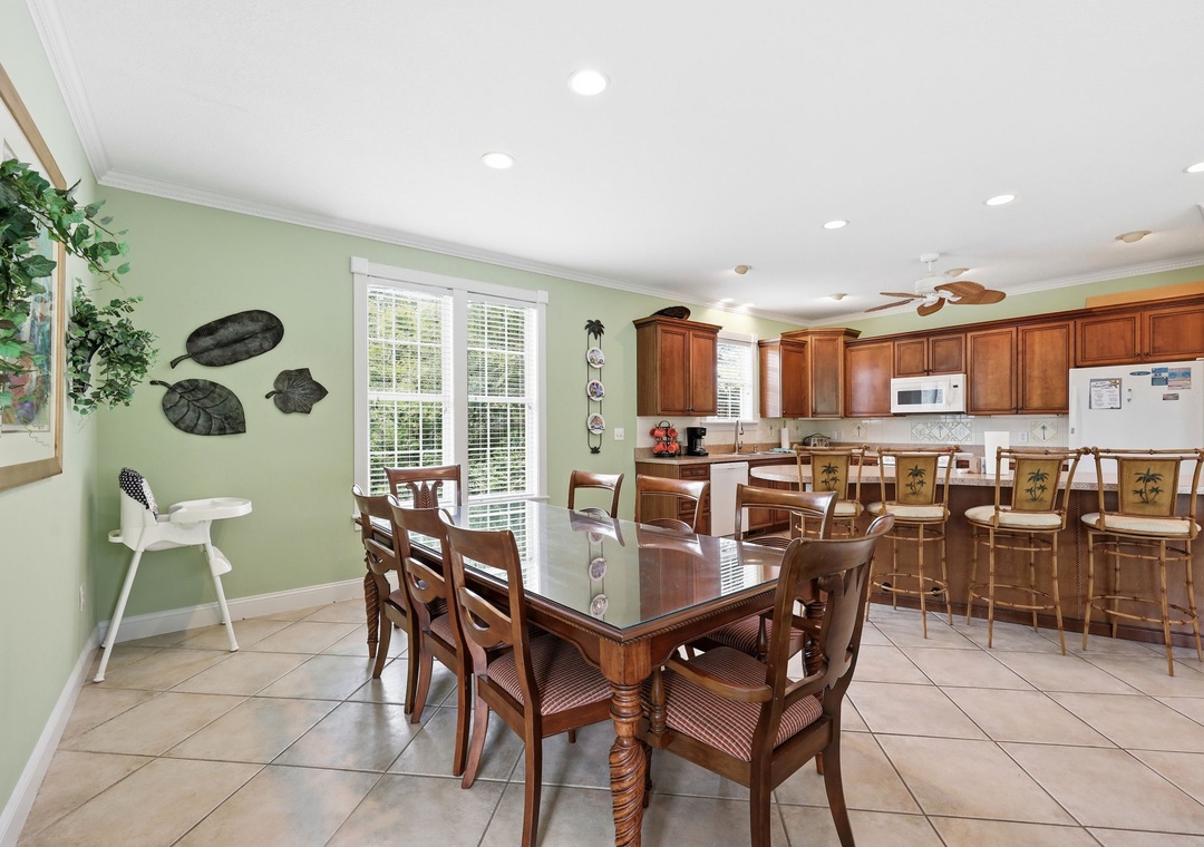 Gather around the dining table for memorable meals, then head to the breakfast bar for casual conversation. Warm wood tones and soft green walls create an inviting space where your group can connect.