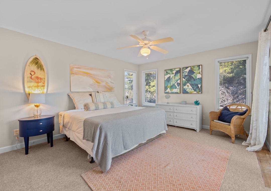 Drift into peaceful sleep in your stylish master suite, where coastal art and a gentle ceiling fan create your perfect retreat.