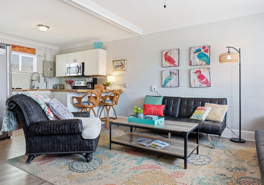Settle into this vibrant coastal retreat where playful bird art adds personality to your open living space. The fully equipped kitchen and cozy seating invite easy, relaxed beach getaways.