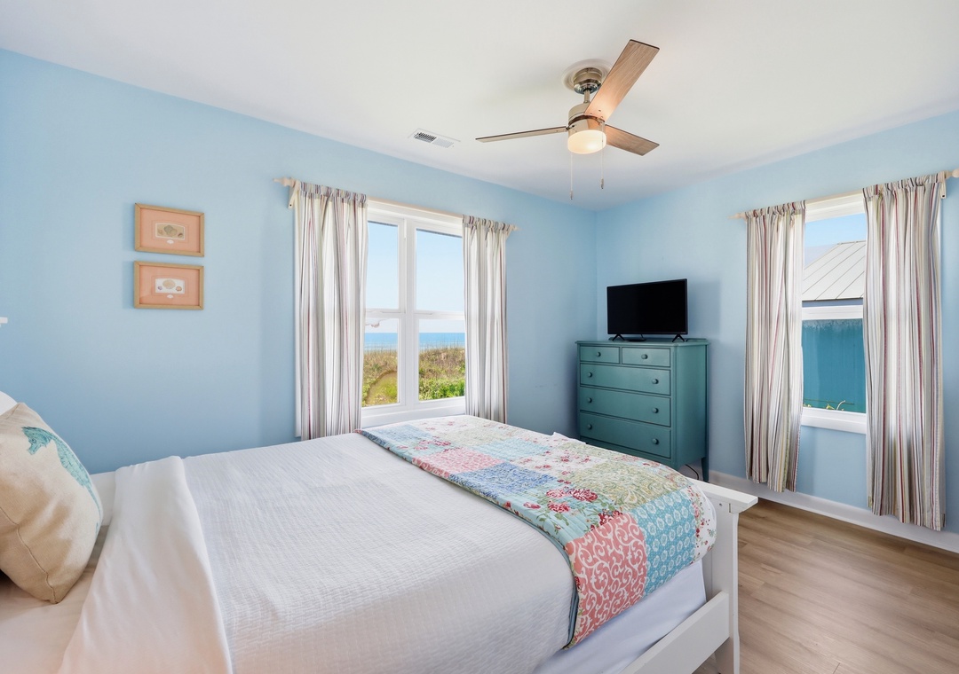Wake up to peaceful ocean views framed by soft curtains in your serene coastal bedroom, where beach breezes and the sound of waves start your perfect day.