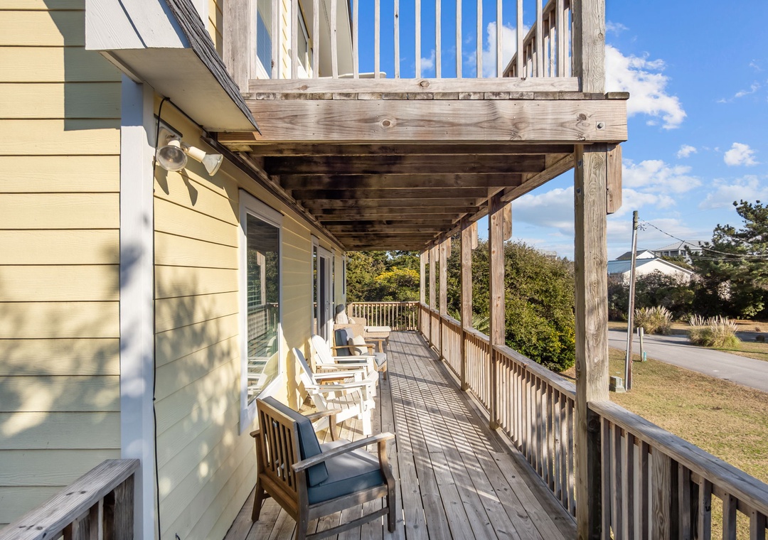 Relax on your private covered deck with comfortable seating while enjoying peaceful neighborhood views.
