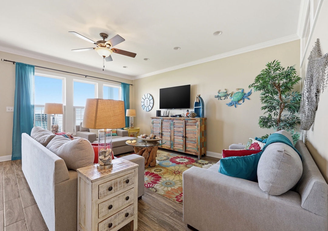 Relax in your bright, coastal-themed living room with comfy seating, ocean views, and charming beach décor that instantly puts you in vacation mode.