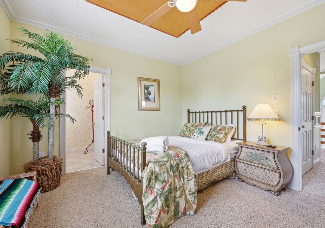 Unwind in your tropical-inspired bedroom with plush linens, elegant furnishings, and a statement tray ceiling—your peaceful retreat after a day of adventure.