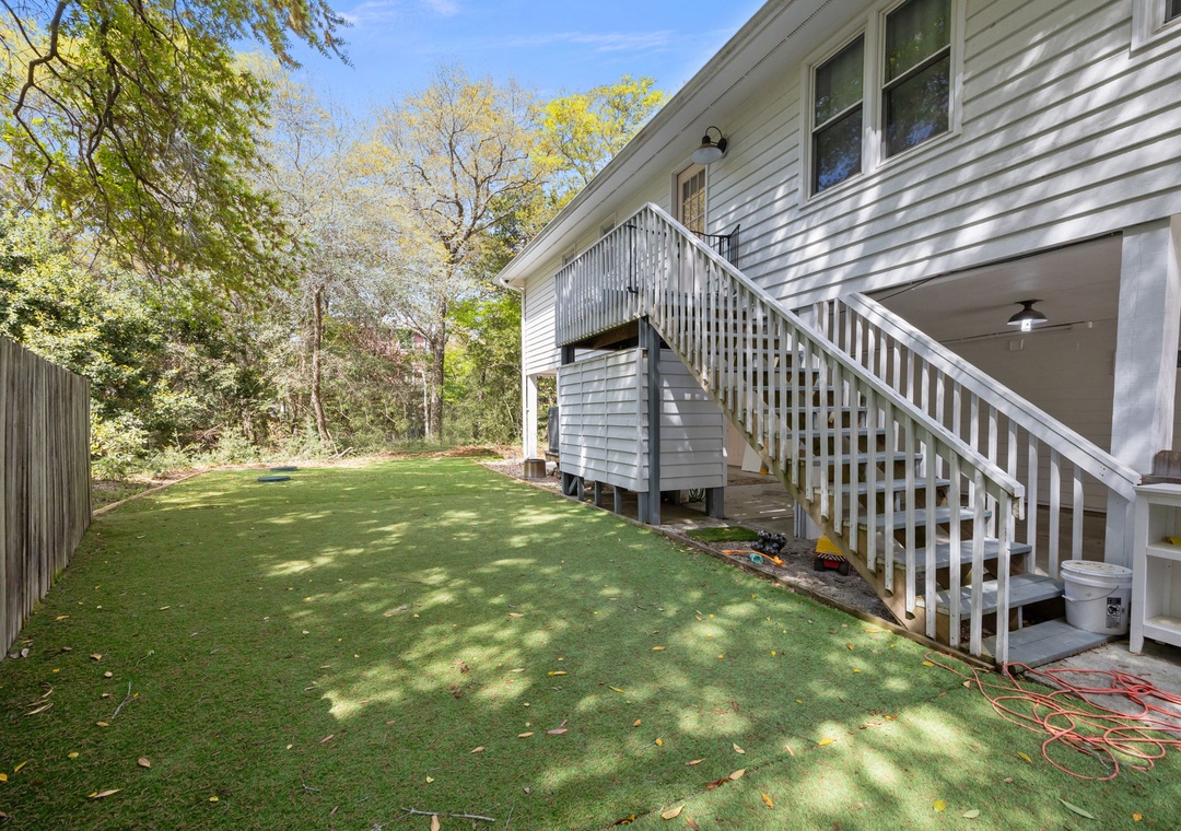 Relax in your private backyard oasis with lush green lawn, shaded by mature trees—perfect for morning coffee or evening gatherings.