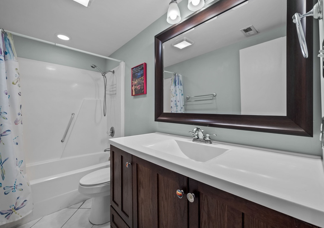 Refresh in your spacious bathroom with modern fixtures, elegant vanity, and convenient tub-shower combo—perfect for unwinding after busy vacation days.
