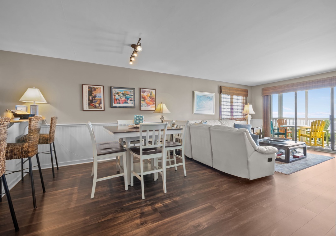 Your bright, open living space flows seamlessly from dining to relaxation, with ocean views through the balcony doors.