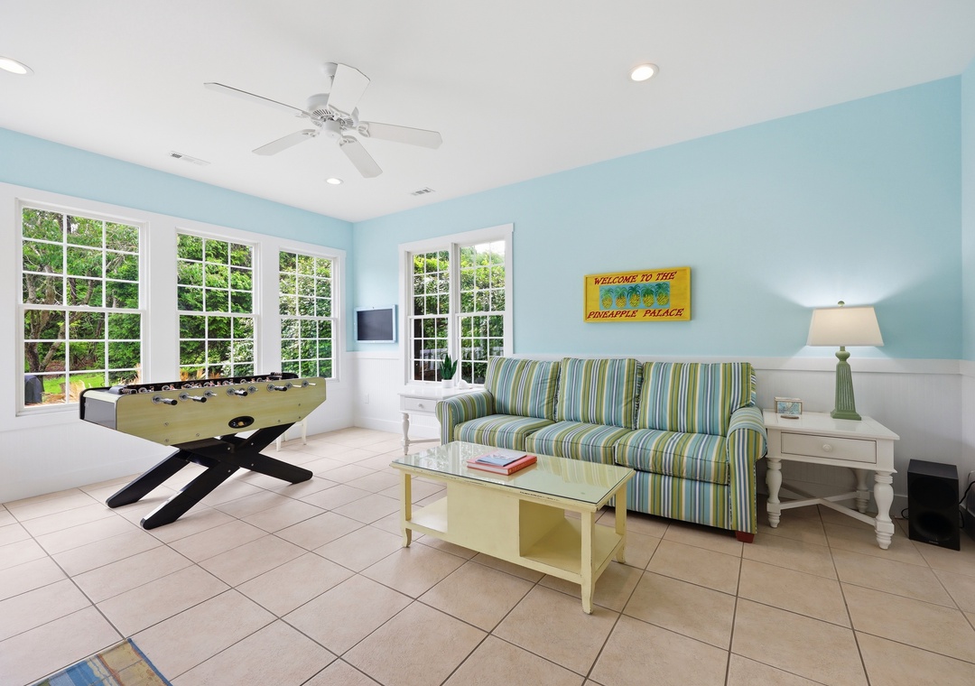 Kick back in your private game room with foosball, comfy seating, and breezy tropical vibes—your perfect spot to unwind between adventures.