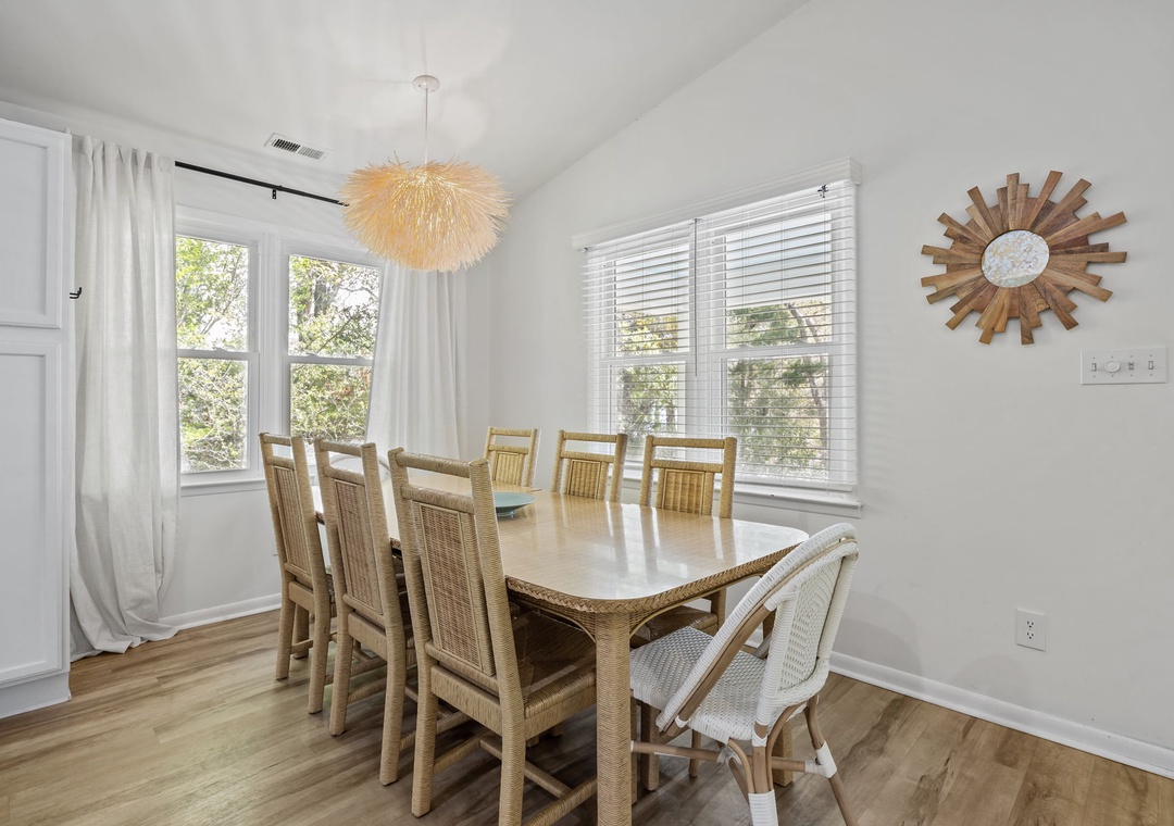 Gather around your spacious dining table where warm wood tones meet bright natural light for memorable meals together.