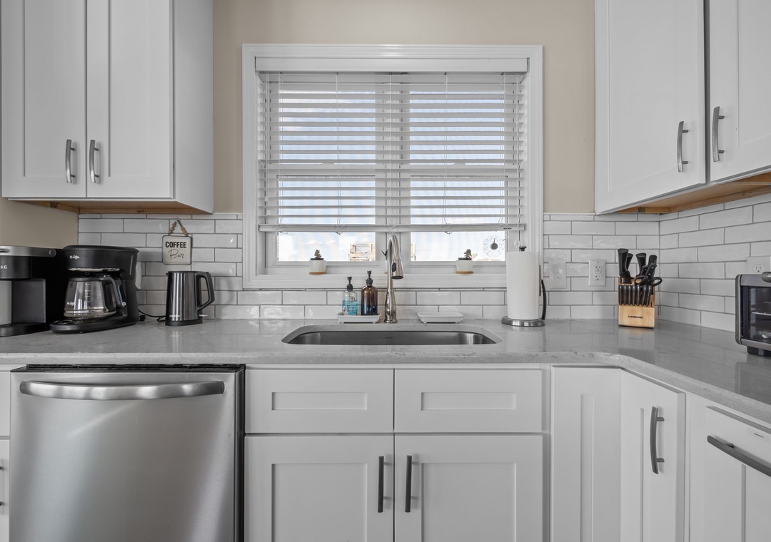 Step into your fully-equipped kitchen with sleek quartz counters, stainless appliances, and coffee maker ready for your perfect morning brew.