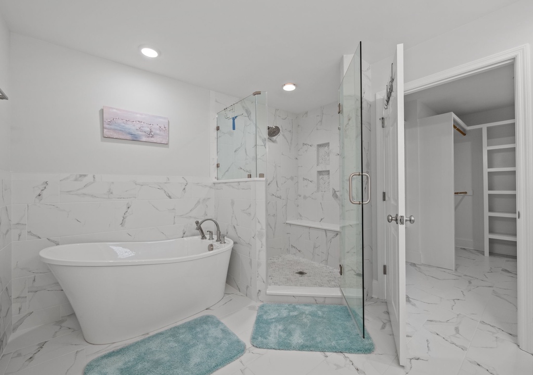 Step into your spa-like ensuite with elegant marble, a soaking tub for relaxing evenings, and a spacious glass shower.