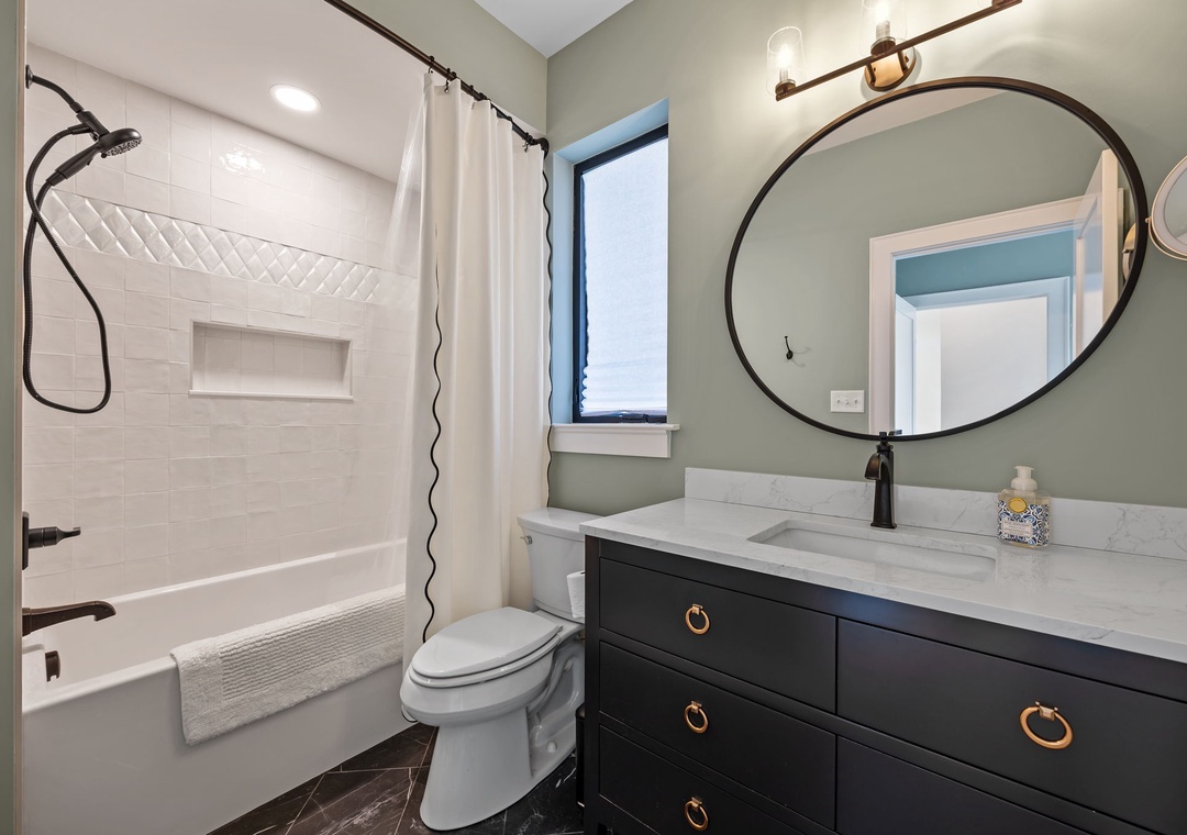 Step into your spa-like bathroom with luxurious rainfall shower, elegant marble vanity, and sophisticated sage green walls for ultimate relaxation.