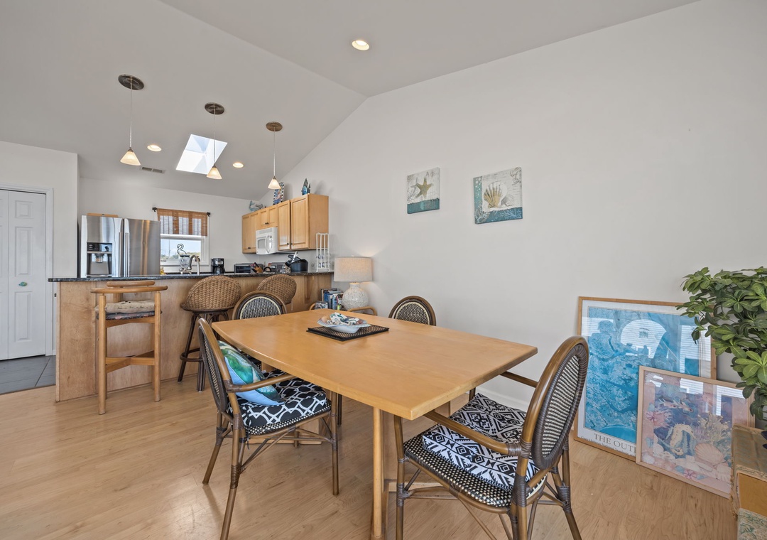 Gather around your spacious dining table for morning coffee or evening meals in this bright, open-concept space with modern kitchen and vaulted ceilings.