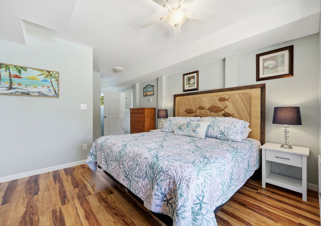 Sink into plush coastal bedding and let warm wood tones wrap you in comfort. Your beachside retreat awaits with charming nautical touches and restful vibes.