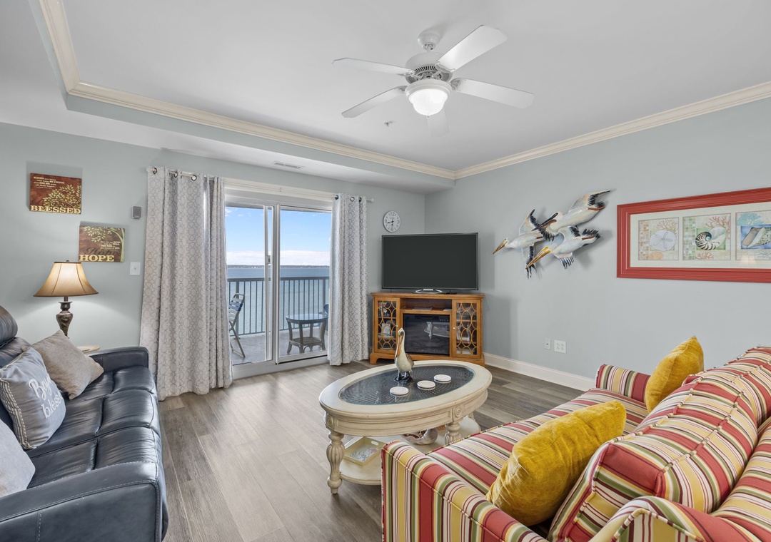 Your coastal living room awaits with plush seating, ocean views, and charming nautical touches that create the perfect beach vacation retreat.