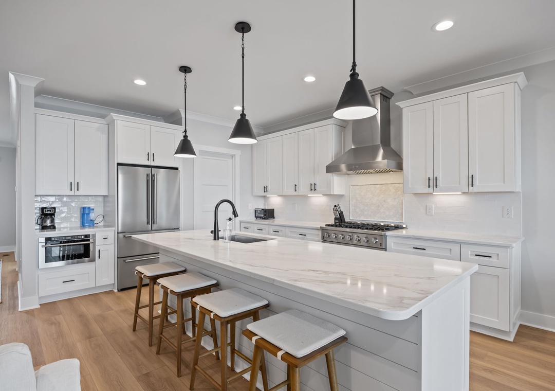 Step into your dream kitchen with pristine white cabinetry, gleaming marble countertops, and modern stainless steel appliances ready for your culinary adventures.