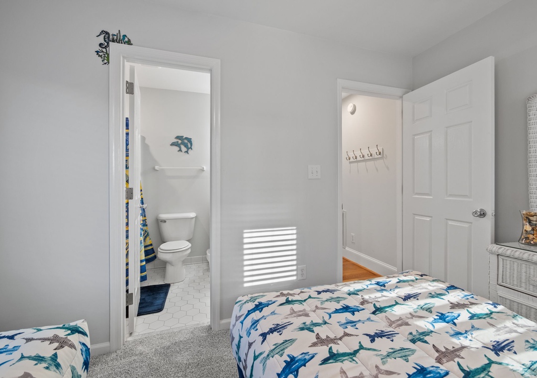 Your shark-themed bedroom offers twin beds and private bathroom access for ultimate comfort and convenience during your stay.