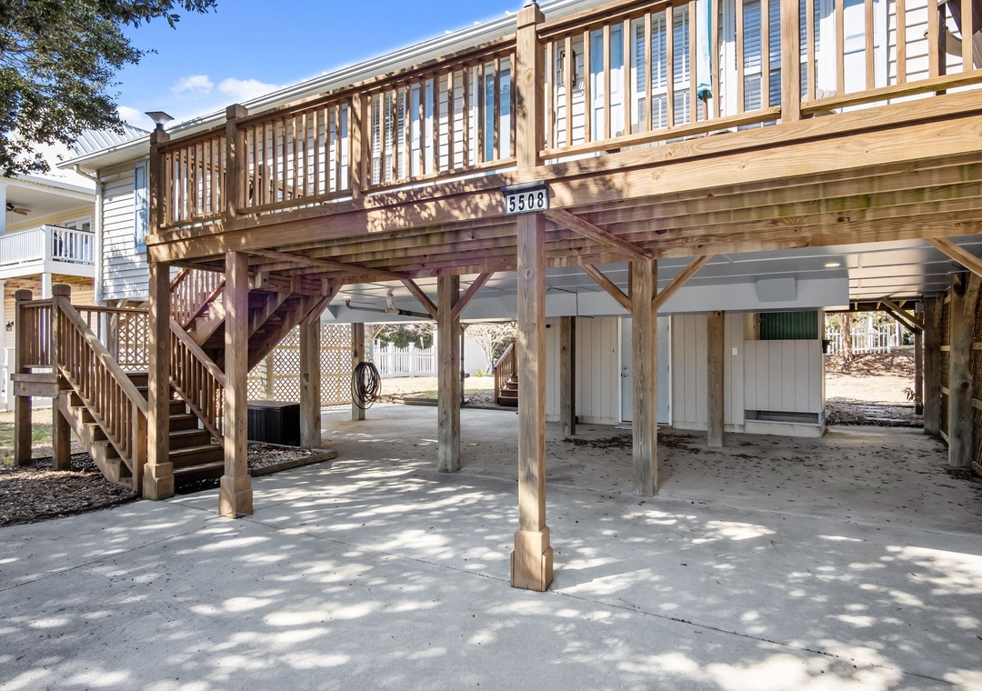 Elevated beach house structure with covered parking and outdoor storage space beneath the main living area.