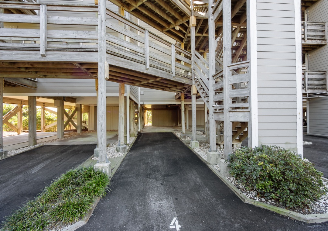 Your covered parking spot awaits beneath charming wooden balconies and railings.