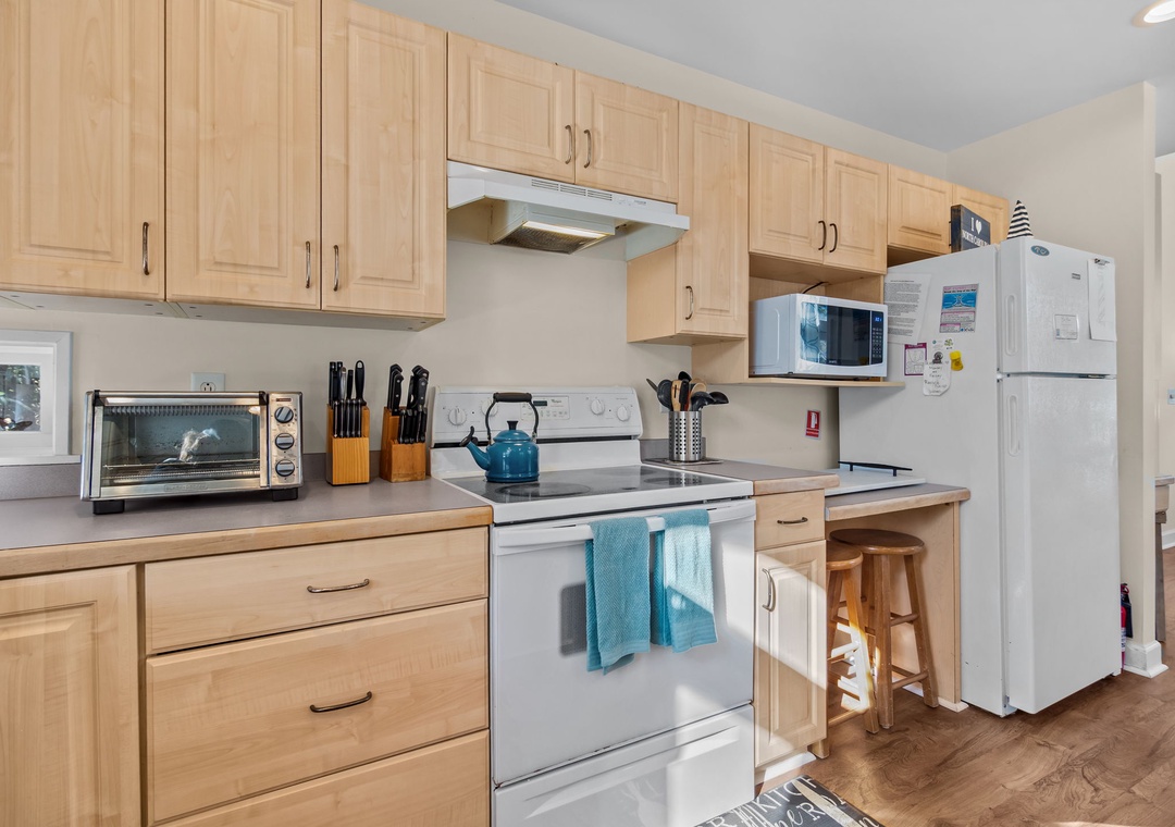 Whip up delicious meals in your fully equipped kitchen with modern appliances, warm wood cabinetry, and everything you need for a perfect stay.