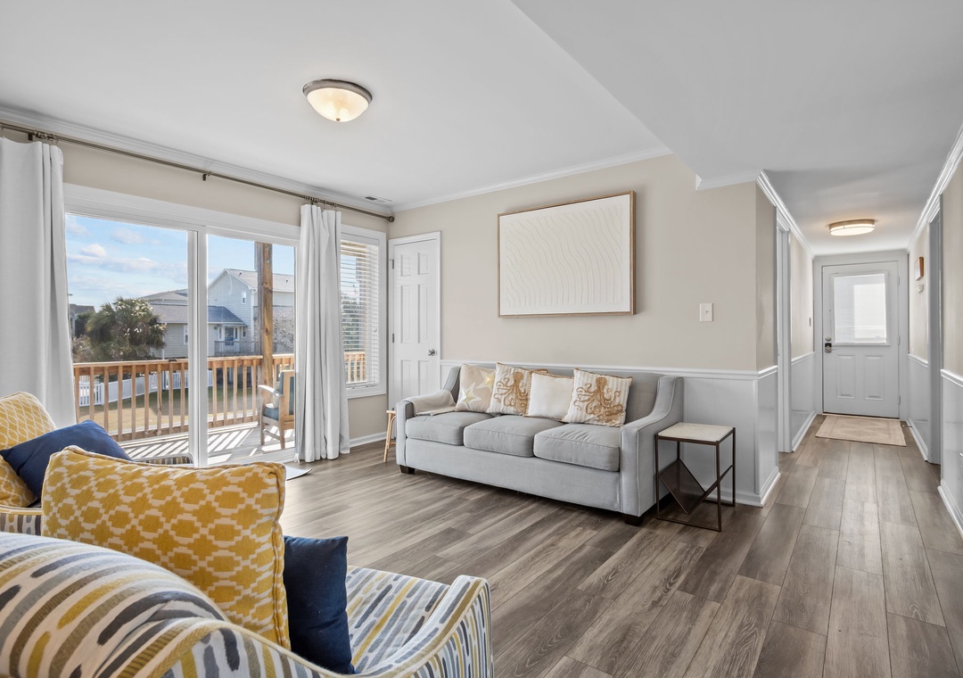 Unwind in this bright living room where coastal comfort meets modern style, with sunshine streaming through your private balcony doors.