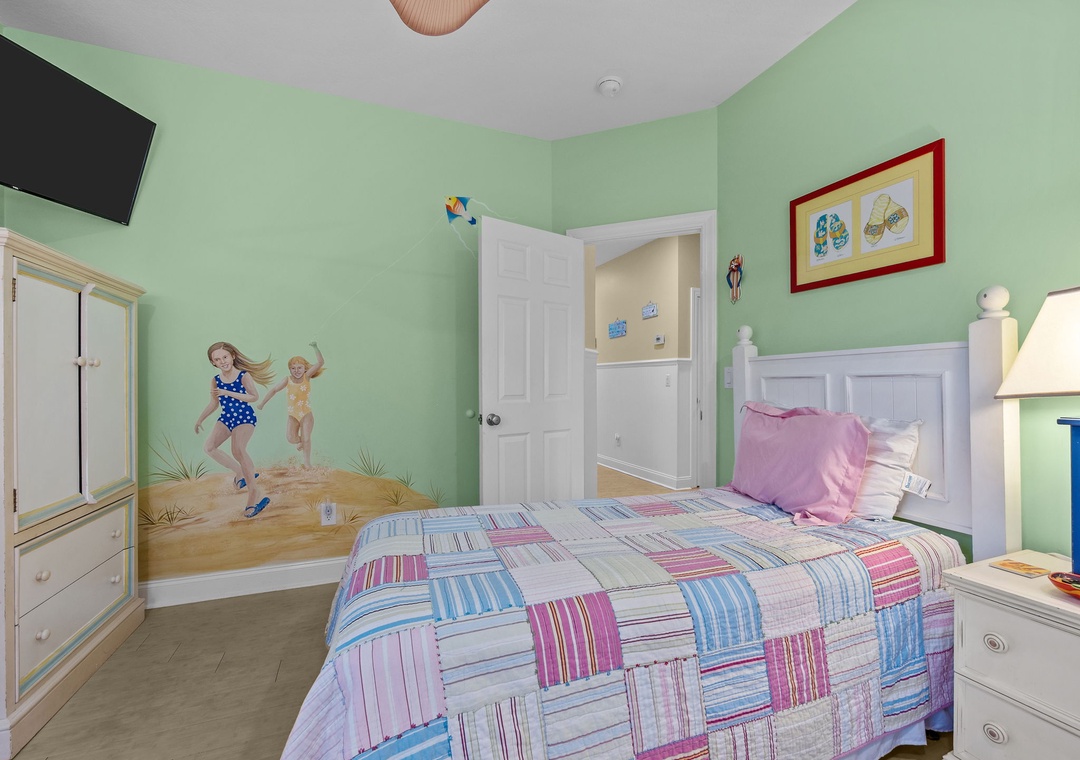 Your little ones will love this cheerful bedroom with playful beach murals, cozy bedding, and fun decor that makes bedtime an adventure.