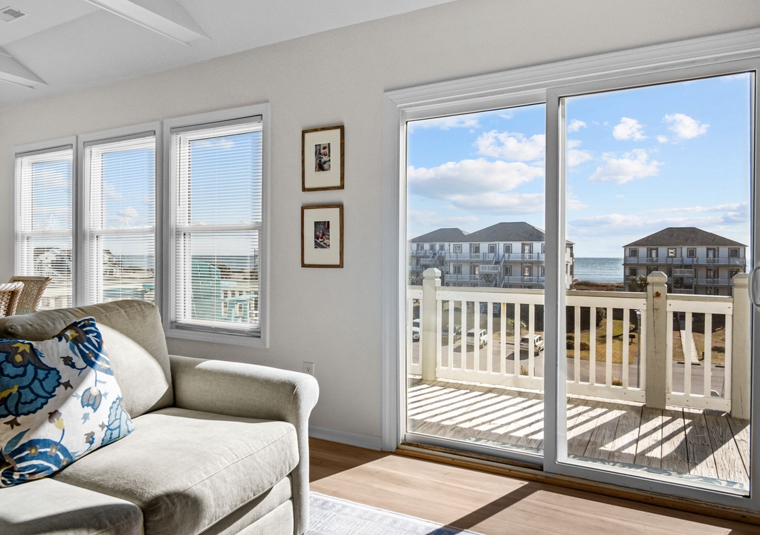 Unwind in your bright living space where natural light floods through large windows, then step onto your private deck to soak in coastal views.