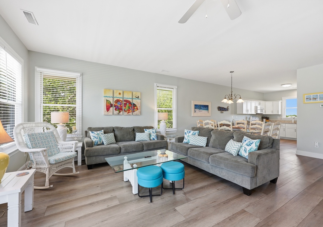 Sink into plush sofas and feel instantly at home in this sunlit living space, where pops of turquoise and coastal art invite you to unwind and connect with your travel companions.
