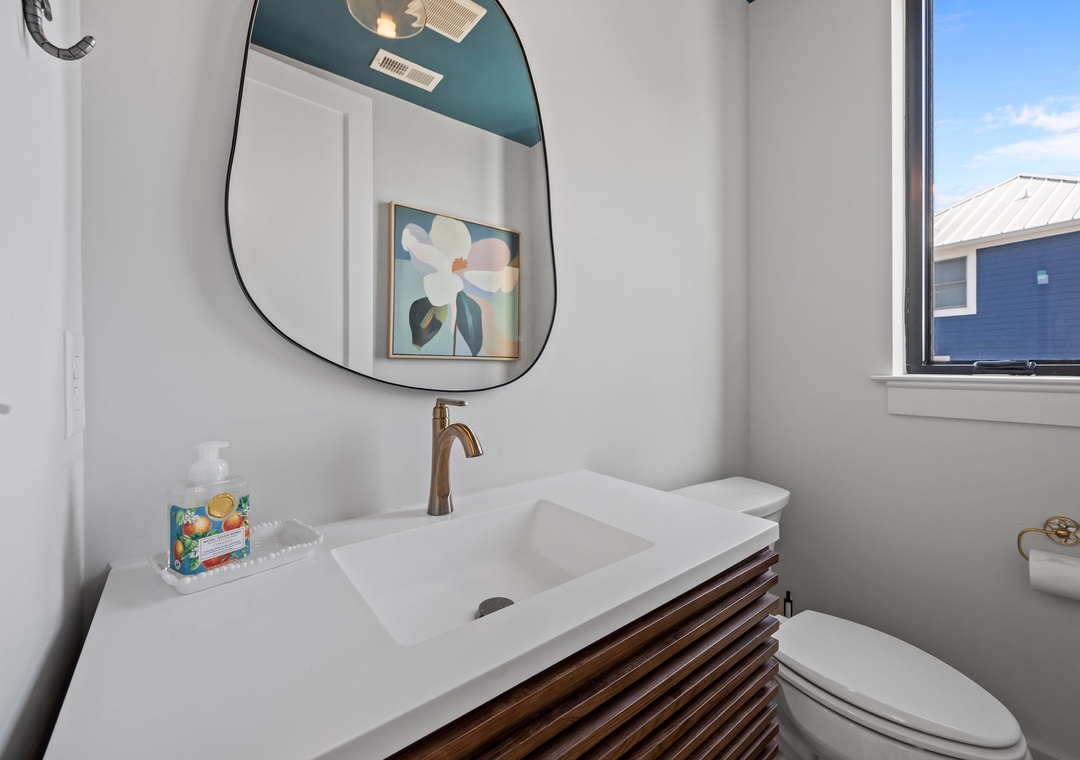 Refresh in your stylishly appointed bathroom with modern fixtures, artistic touches, and natural light streaming through the window.