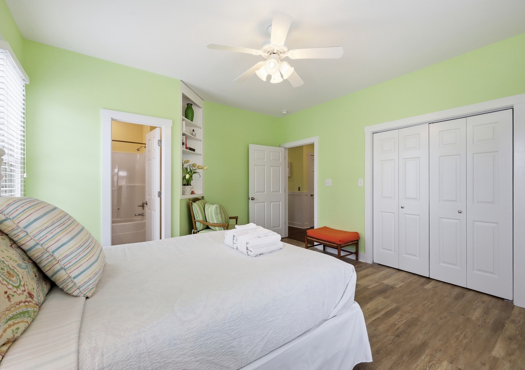 Relax in your cheerful, light-filled bedroom with soft linens, ceiling fan, and ensuite bathroom. Unpack in the spacious closets and unwind in the fresh, calming atmosphere.