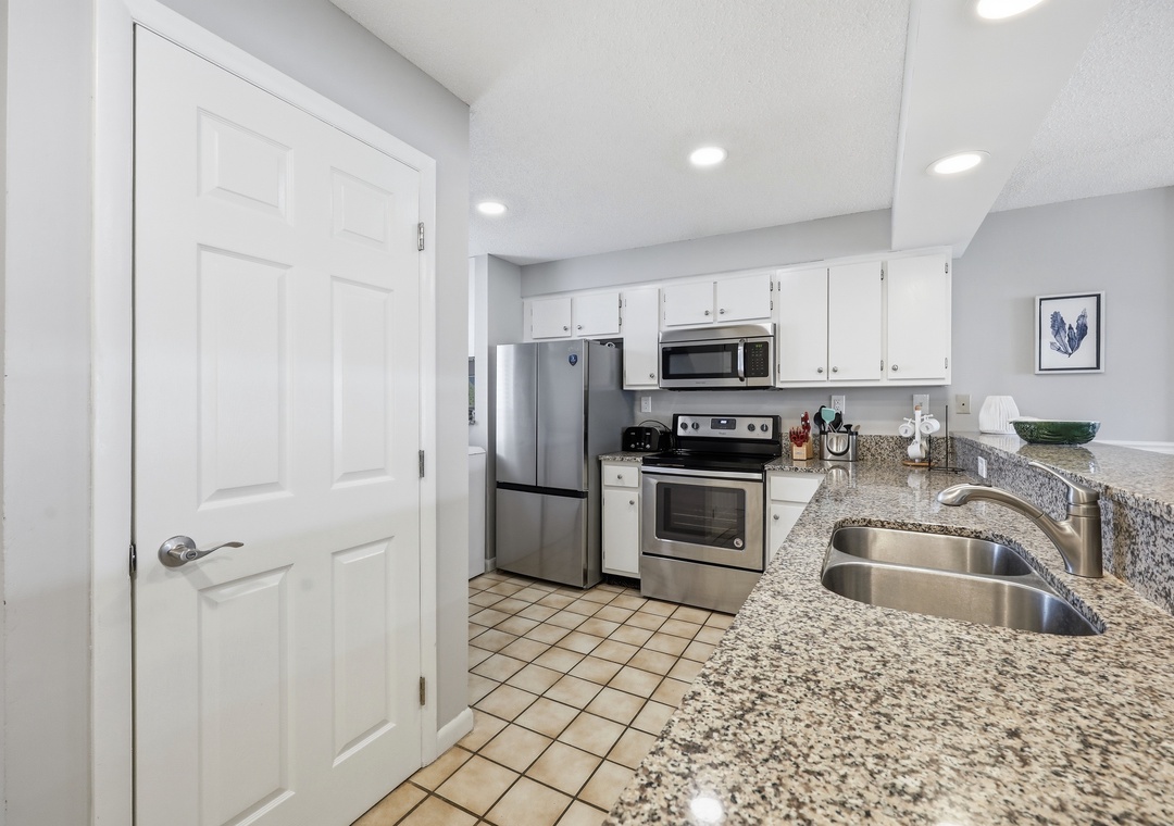 Your fully equipped kitchen features granite counters, stainless steel appliances, and everything you need to whip up delicious vacation meals together.