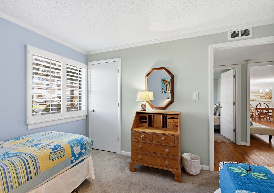 Unwind in your peaceful bedroom retreat with calming coastal tones, comfortable beds, and warm wood accents that create the perfect space for restful nights.