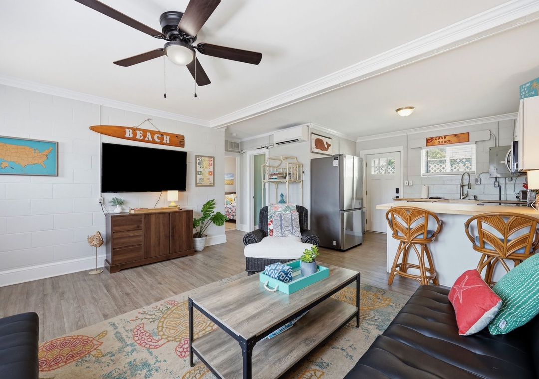 Relax in your bright, beachy living space with coastal décor, comfy seating, and a full kitchen with a breakfast bar—perfect for unwinding after a day exploring the shore.