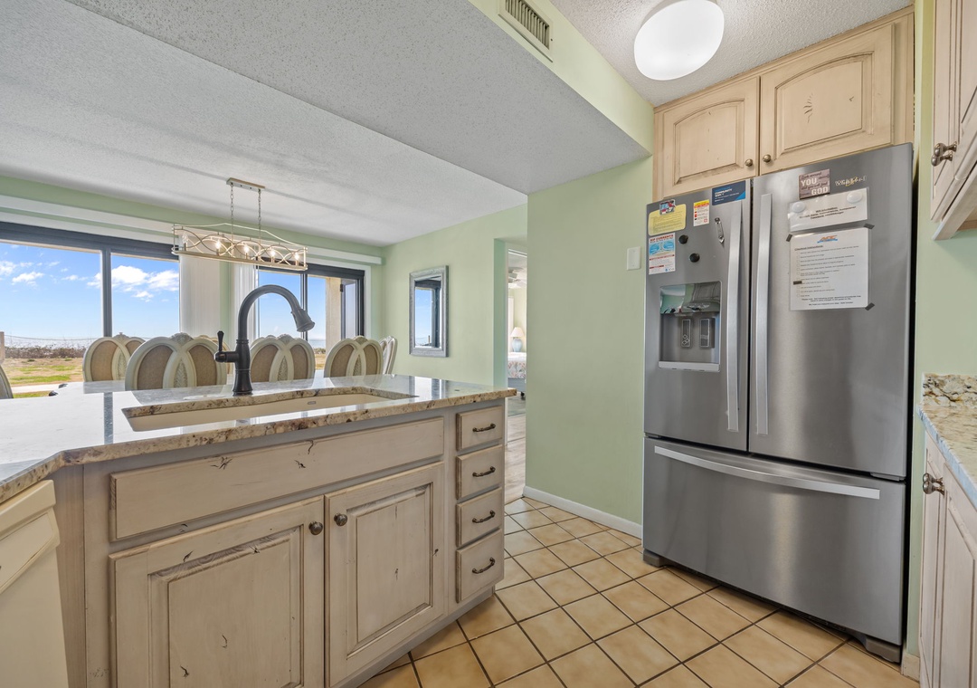 Your fully-equipped kitchen awaits with granite counters, stainless appliances, and stunning views to inspire your culinary adventures.
