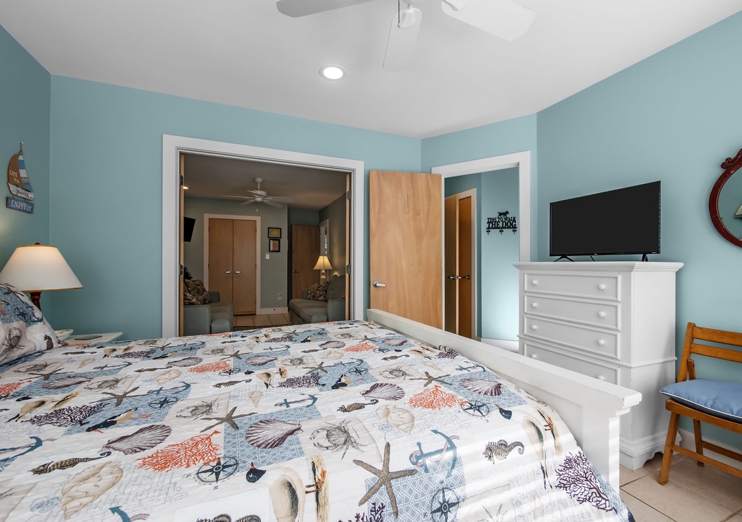 Your tranquil bedroom features coastal charm with sea-life bedding and calming aqua walls, perfect for restful nights.